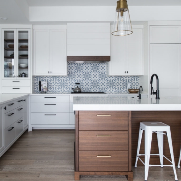 Kitchen with custom white cabinets and wood island cabinets